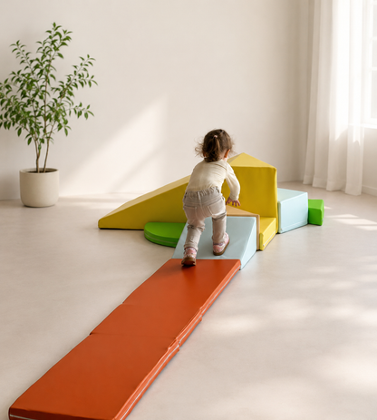 Child playing on a colorful geometric play set in a bright room with a plant.